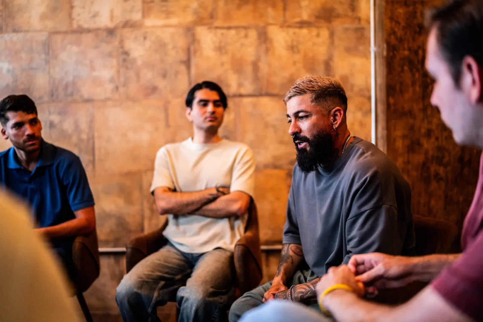 Men's support group discussion, man speaking